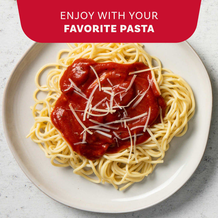 McCormick Thick &amp; Zesty Spaghetti sauce mix with a bowl of pasta and a pot of sauce.