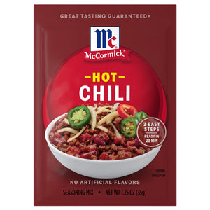A packet of Mccormick Hot Chili Seasoning Mix 1.25 Oz features a bowl of hearty chili topped with shredded cheese and sliced jalapeños against a deep red background.