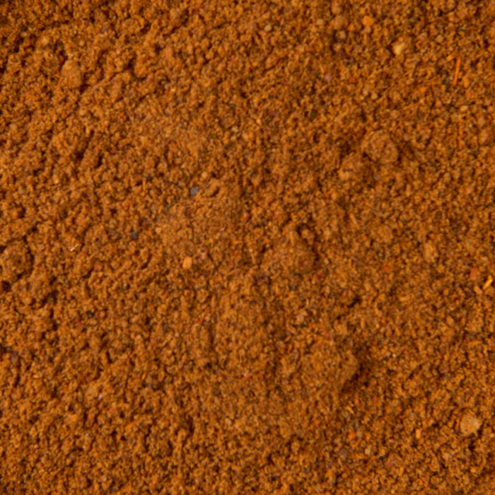 A close-up view of reddish-brown powder, which is Mccormick Chili Seasoning Mix 1.25 Oz.