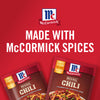 ['Two McCormick Original Chili seasoning packets with a red background.']