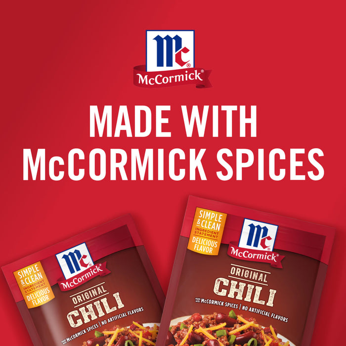 ['Two McCormick Original Chili seasoning packets with a red background.']