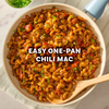 A red background features text suggesting to add cinnamon to a recipe and serve over spaghetti, alongside a bottle of McCormick Cinnamon Ground and a packet of Mccormick Chili Seasoning Mix 1.25 Oz.