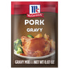 A McCormick Pork Gravy mix packet with a picture of a pork chop with gravy on top.