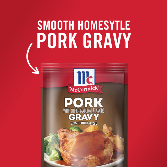 ['A package of McCormick Pork Gravy with a picture of a pork chop with gravy on top.']