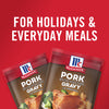 ['Two McCormick Pork Gravy packets with a red background.']