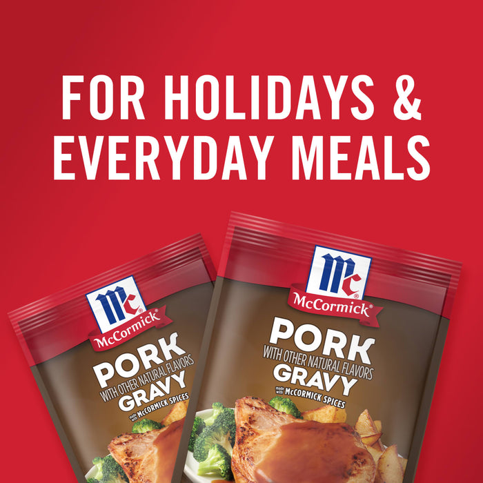 ['Two McCormick Pork Gravy packets with a red background.']