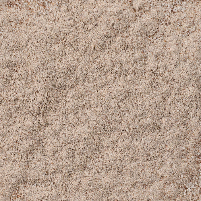 A close-up view of the finely textured, light brown powder that is Mccormick Au Jus Gravy Mix 1 Oz.
