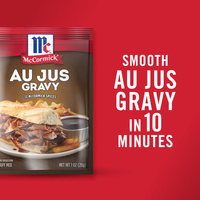 ['A package of McCormick Au Jus Gravy mix with a sandwich and gravy on a plate.']