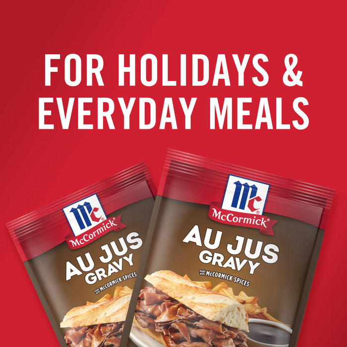 ['Two McCormick Au Jus Gravy packets with a sandwich on each.']