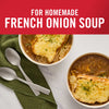['Two bowls of French onion soup topped with melted cheese and toasted bread.']