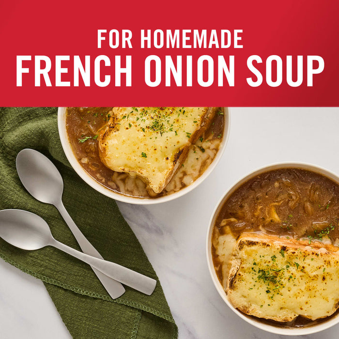 ['Two bowls of French onion soup topped with melted cheese and toasted bread.']