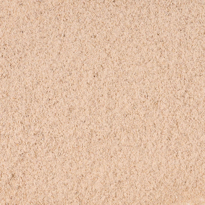 A close-up view of the finely textured, light brown powder, representing Mccormick Brown Gravy Mix .87 Oz