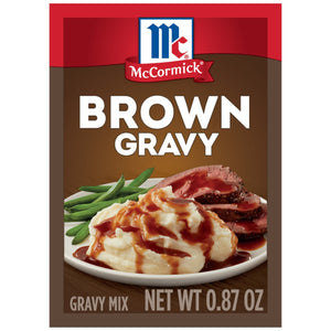 McCormick Brown Gravy mix package with a picture of mashed potatoes green beans and roast beef covered in gravy.