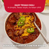 A bowl of hearty beef chili topped with melted cheddar cheese and jalapeño slices made using Mccormick Tex Mex Chili Seasoning Mix 1.25 Oz.