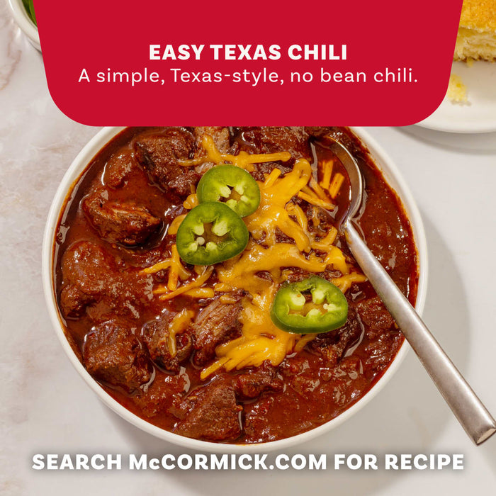 A bowl of hearty beef chili topped with melted cheddar cheese and jalapeño slices made using Mccormick Tex Mex Chili Seasoning Mix 1.25 Oz.