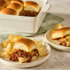 A plate of savory sloppy joe sliders prepared with Mccormick Tex Mex Chili Seasoning Mix 1.25 Oz served alongside a pile of crunchy potato chips.