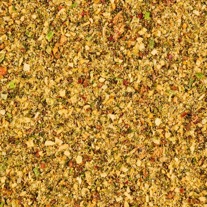 A close-up of a blend of spices including dried herbs garlic and red pepper flakes.