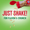 A red jar with a red lid labeled McCormick, with the words Just Shake! For Flavor &amp; Crunch in red and green.