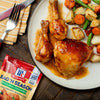 ["A plate of roasted chicken with potatoes, carrots, and green beans, seasoned with McCormick Bag'n Season Original Chicken."]