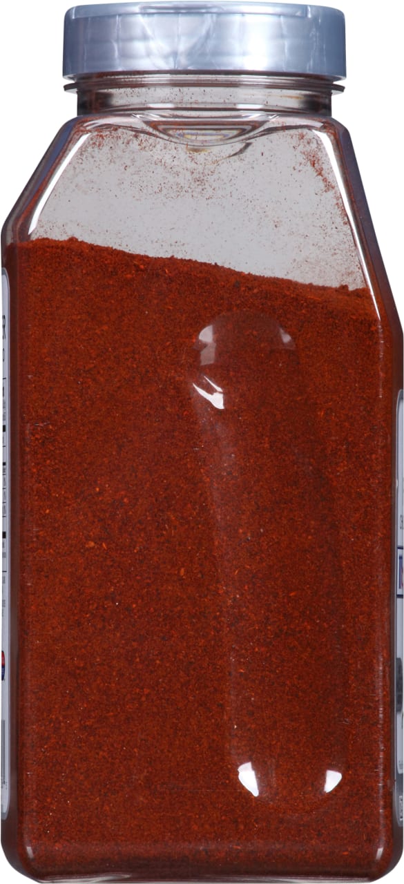 A glass jar filled with red chili powder.
