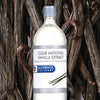 A bottle of McCormick Culinary Clear Imitation Vanilla Extract surrounded by vanilla beans.