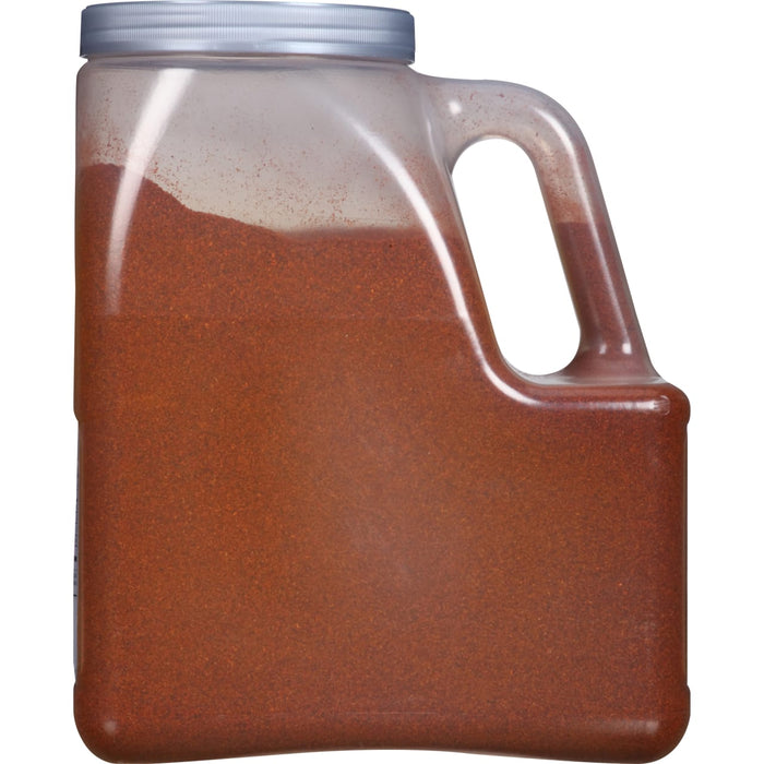 A clear plastic jar filled with red chili powder.