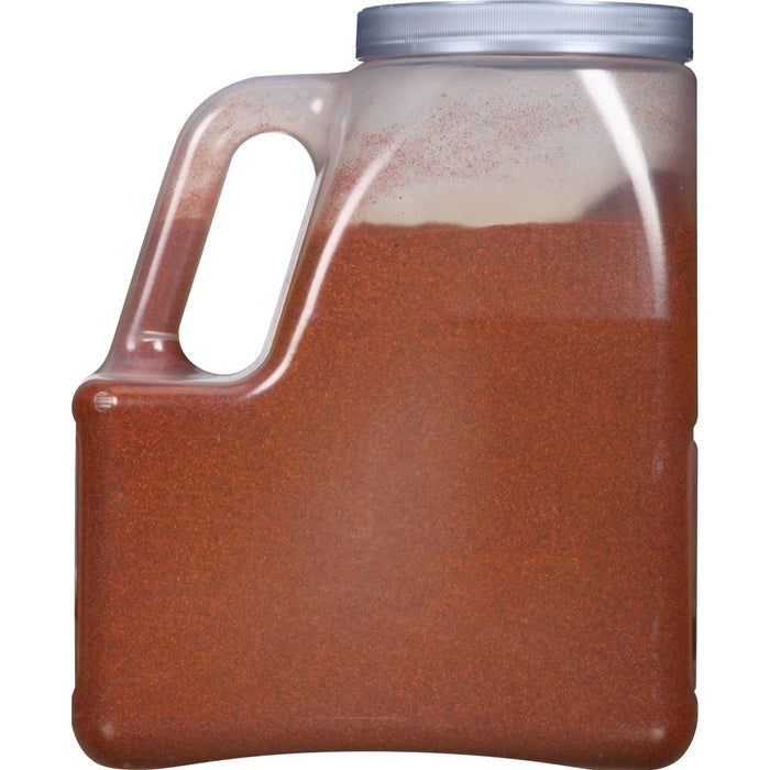 A clear plastic container filled with red chili powder.