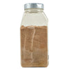 A glass jar with a silver lid filled with brown spices.