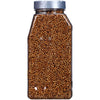 A clear plastic jar filled with coriander seeds.