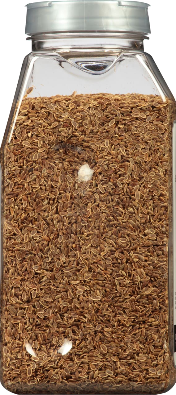 A clear plastic jar filled with dried dill seeds.
