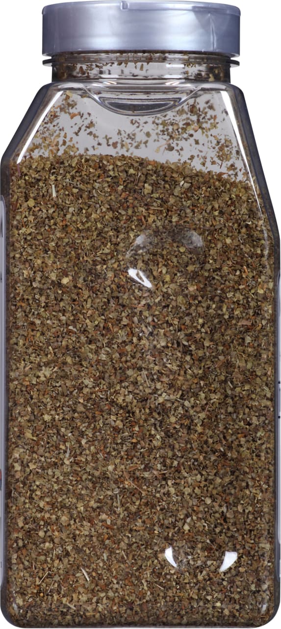 A clear plastic jar filled with dried oregano.