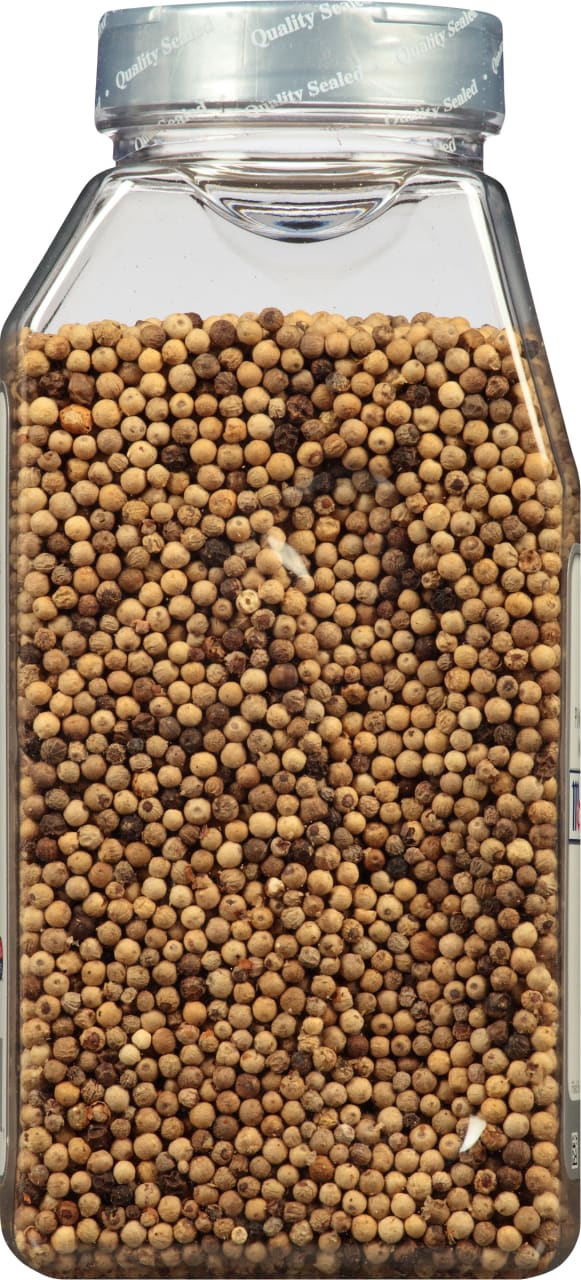 A clear plastic jar filled with white peppercorns.