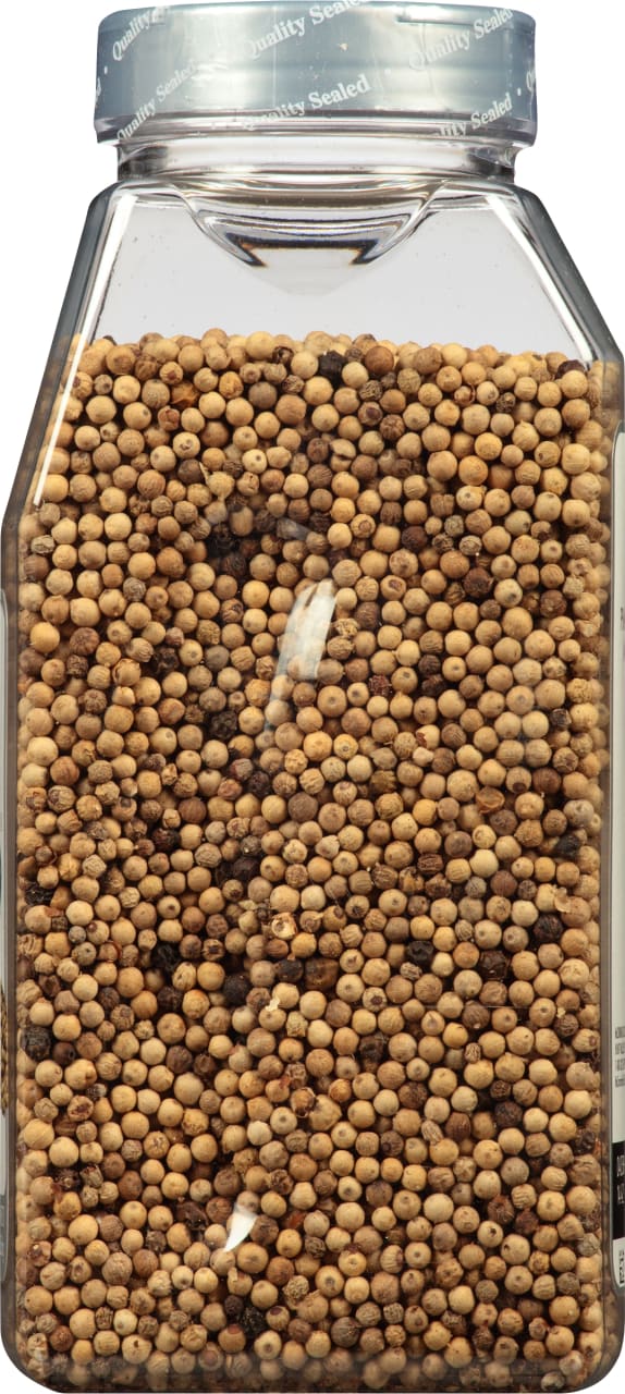 A clear jar filled with white peppercorns.