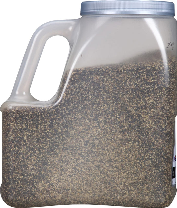 A plastic container filled with black peppercorns.