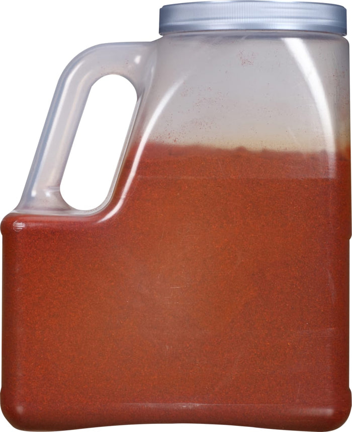A clear plastic container filled with red chili powder.