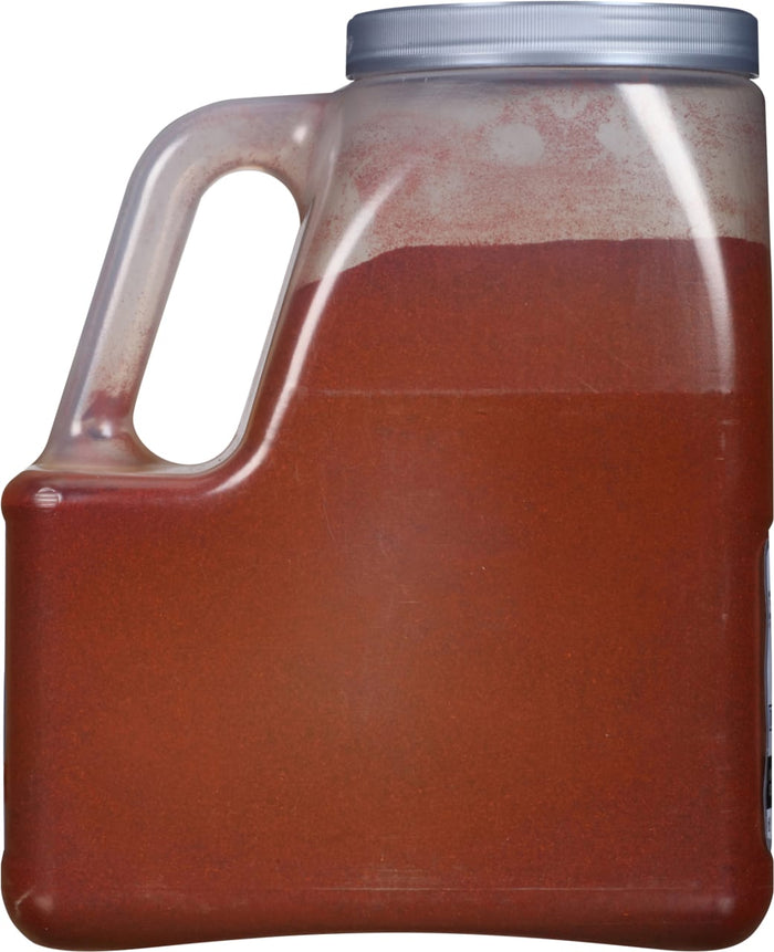 A plastic container filled with red chili powder.