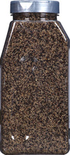 A close-up of a glass jar filled with black peppercorns.