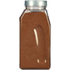 A plastic jar filled with brown ground cinnamon.