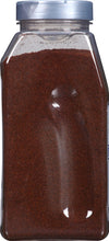 A clear plastic jar filled with ground red pepper.