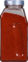 A clear plastic jar filled with red chili powder.