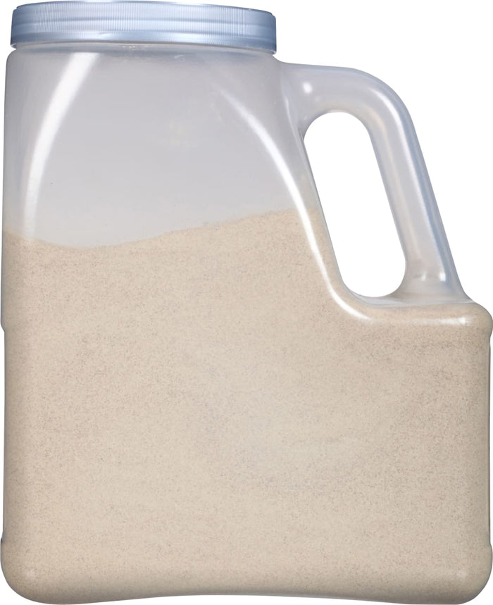 A clear plastic container with a handle filled with a beige powder.
