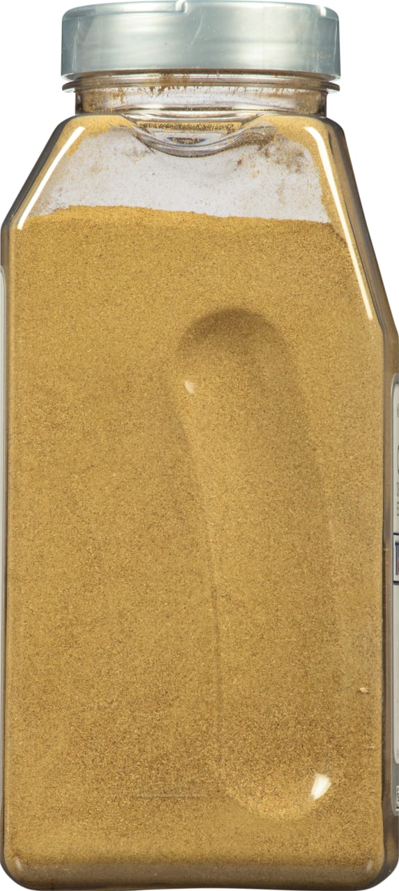 A glass jar filled with ground cumin.