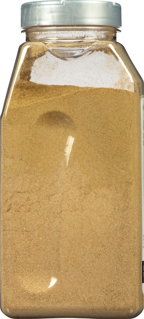 A glass jar filled with ground cumin.