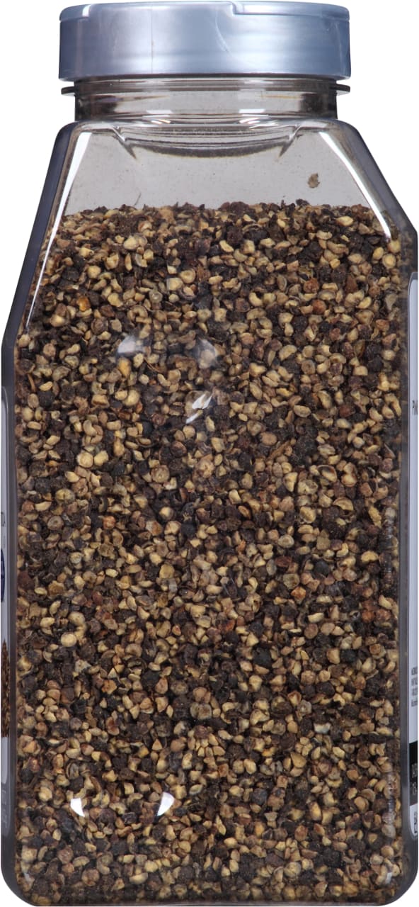 A plastic jar filled with black peppercorns.