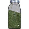 A glass jar filled with dried parsley.