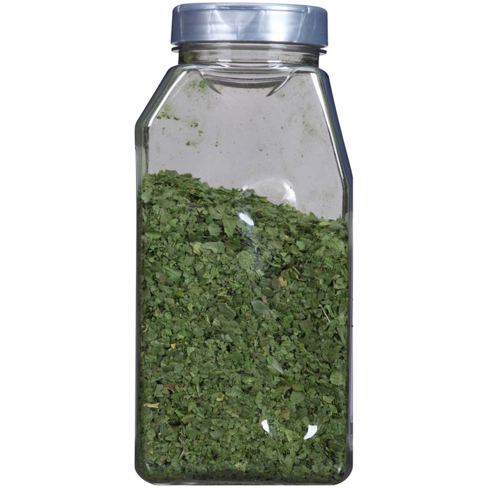 A glass jar filled with dried parsley.