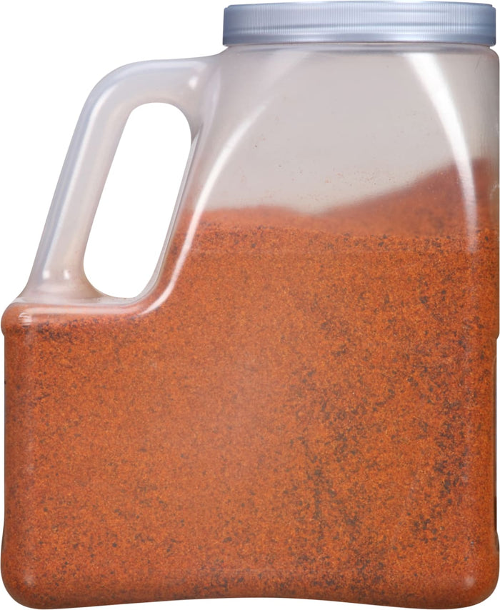 A clear plastic container filled with red chili powder.