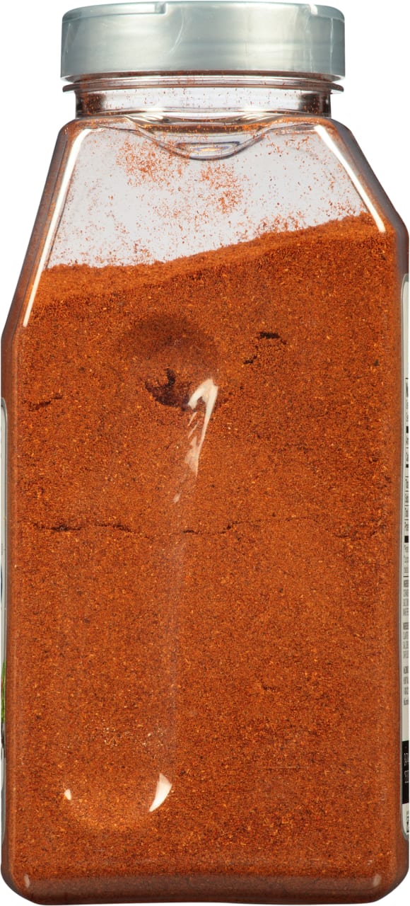 A plastic jar filled with red chili powder.