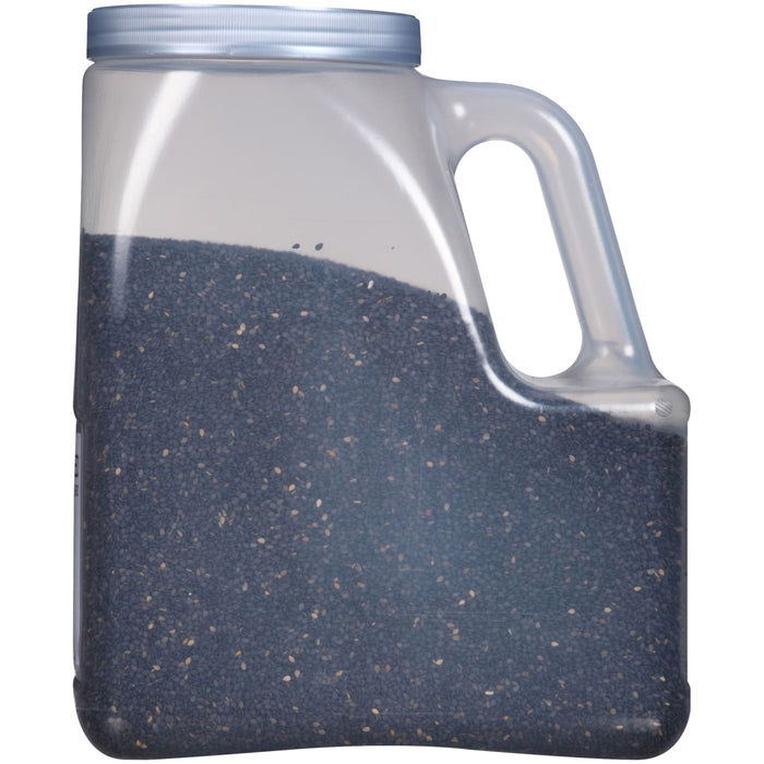 A plastic container filled with black sesame seeds.