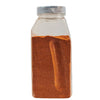 A clear plastic jar filled with a brown spice.